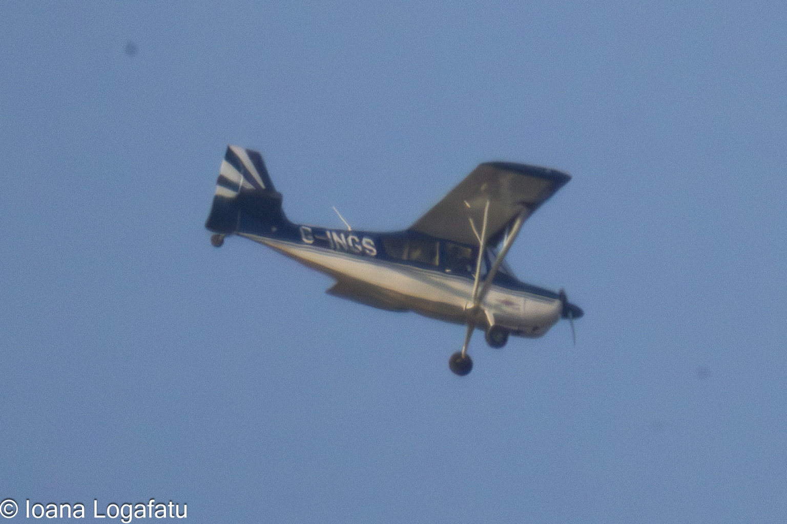Vintage aircraft soaring through a clear blue sky